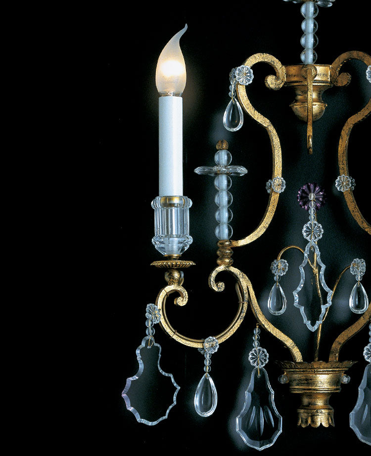 Luxury wall light in golden wrought iron and clear crystals